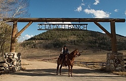 Shawn and Luke under the C Lazy U Entrance sign