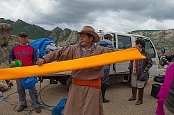 Baagii Preparing a Sash for A Deel