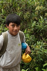 A boy on the trail receives a new ball from Ali