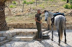 Gimmy Watering a Horse at  Lunch on the Trail