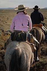 Bobbi carries Shawn 300 2.8 lens on the horse on the ride To the Wild horses with Blue Sky Sage