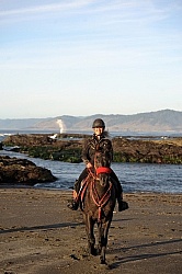 Lari Shea of Ricochet Ridge Ranch riding on the beach