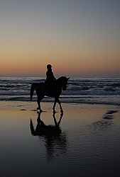 Riding on the beach at Sunset at Ricochet Ridge Ranch