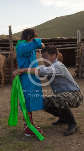 Baagii ties the Sash on his grandaighter Buggins Deel