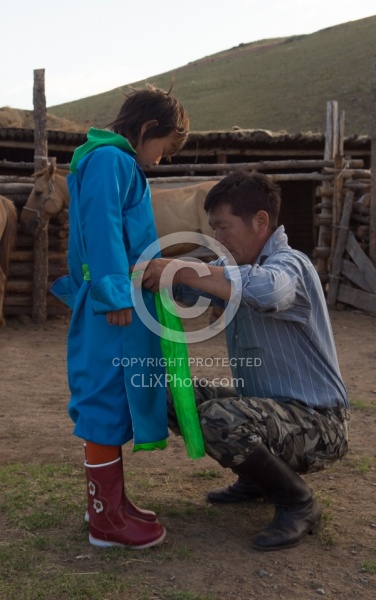 Baagii ties the Sash on his grandaighter Buggins Deel