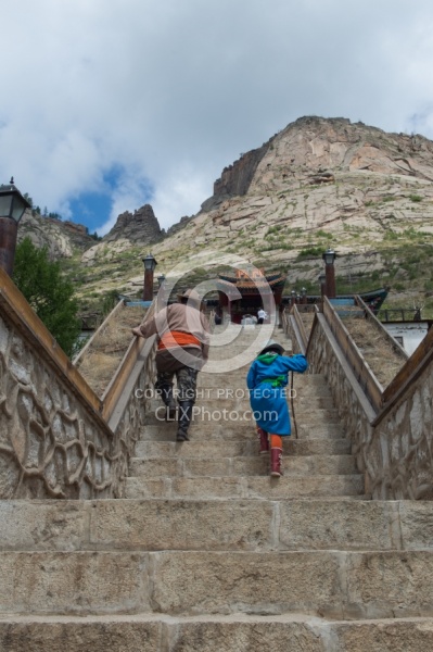 Baagii and Bugiin climb the Stairs to the Monastery