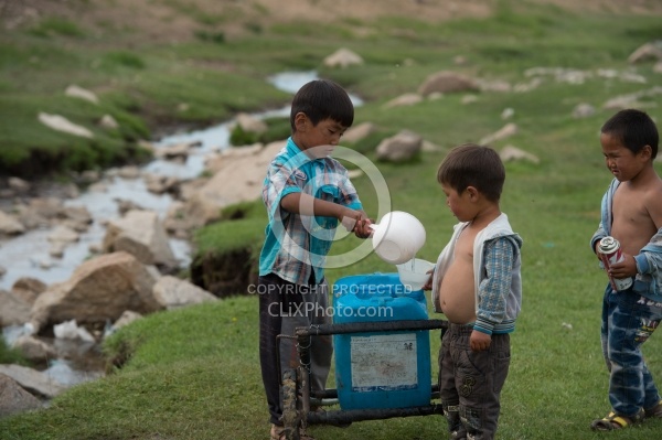 Kids Collecting Water from the River