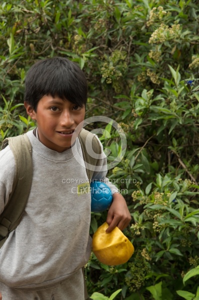 A boy on the trail receives a new ball from Ali