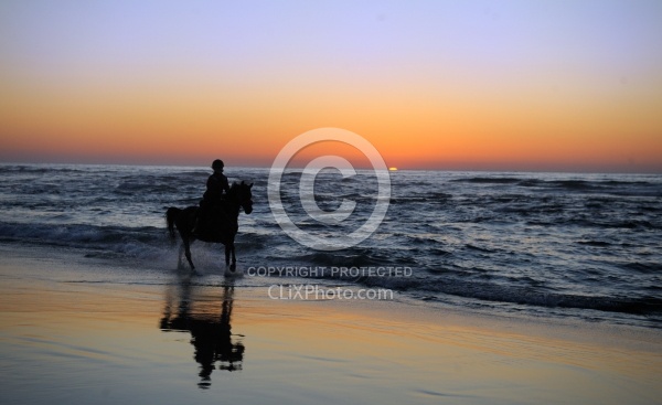Riding on the beach at Sunset at Ricochet Ridge Ranch